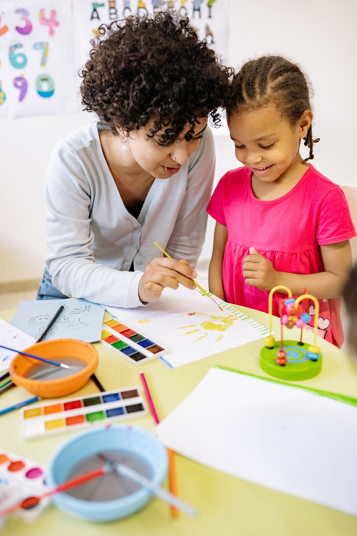 Teacher painting with student